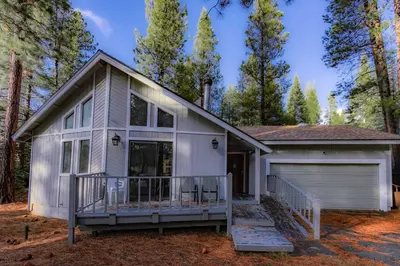 a small white house with a garage at Oglala Little Lodge - For 4 in South Lake Tahoe