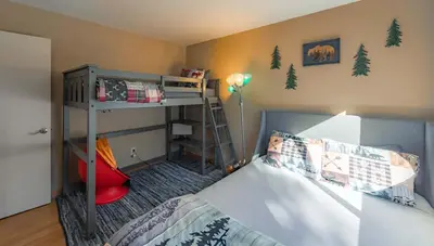a small bedroom with a bunk bed and a ladder at Bakersfield Basecamp - Meyers Escape in South Lake Tahoe