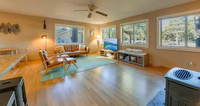 a living room with a couch and a tv at Bakersfield Basecamp - Meyers Escape in South Lake Tahoe