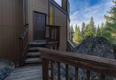 a wooden porch with a door and stairs to a house at Spooner Summit For 6ppl in Zephyr Cove