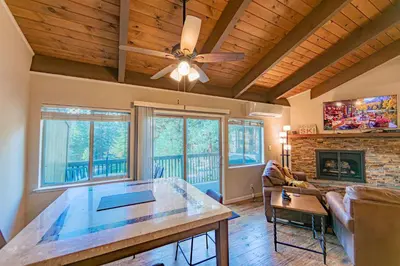 a living room with a ceiling fan and a table at Spooner Summit For 6ppl in Zephyr Cove