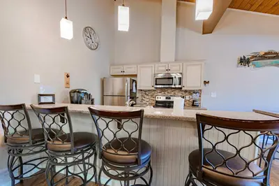 a kitchen with a counter with four bar stools at Spooner Summit For 6ppl in Zephyr Cove
