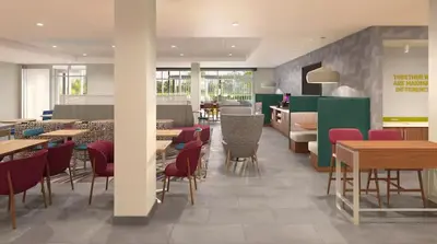 a restaurant with wooden tables and chairs and tables and chairsktop at Home2 Suites By Hilton Carson City in Carson City