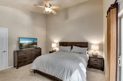 a bedroom with a bed and a ceiling fan at Meadow Chalet townhouse in South Lake Tahoe