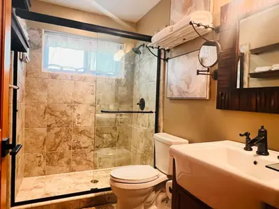 a bathroom with a shower and a toilet and a sink at Cozy Cabin and Modern Stay in Arnold Near Bear Valley in Arnold