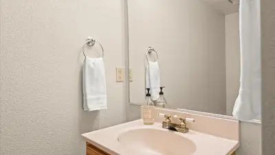 a bathroom with a sink and a mirror at NEW Cityside Stay 3BR Family Retreat Near DT with Patio in Reno