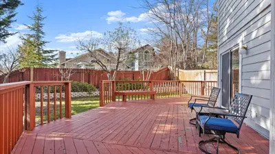 a patio with two chairs on a wooden deck at NEW Cityside Stay 3BR Family Retreat Near DT with Patio in Reno
