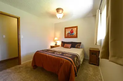 a small bedroom with a bed and a window at Blue Bird Ranch in Oakhurst