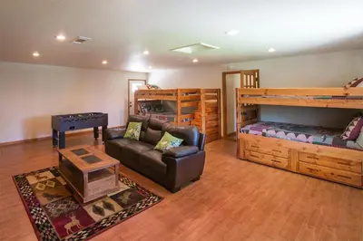 a living room with a couch and bunk beds at Blue Bird Ranch in Oakhurst