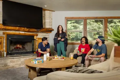a group of people sitting in a living room at Tahoe Cabin - Hot Tub, Fire Pit, Pool Table, minutes from Heavenly in South Lake Tahoe