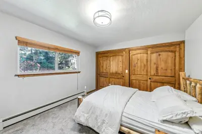 a bedroom with a bed and a window at Tahoe Cabin - Hot Tub, Fire Pit, Pool Table, minutes from Heavenly in South Lake Tahoe