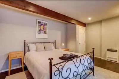 a bedroom with a bed with a metal railing at Tramway near Heavenly/ Dogs OK/ New Heating & Air in Stateline