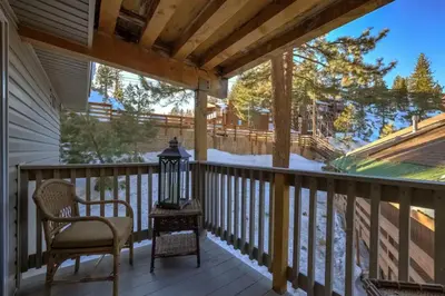 a screened porch with a chair and a lantern at Tramway near Heavenly/ Dogs OK/ New Heating & Air in Stateline