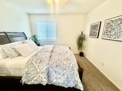 a bedroom with a bed and a window at Tranquil Getaway in Fresno