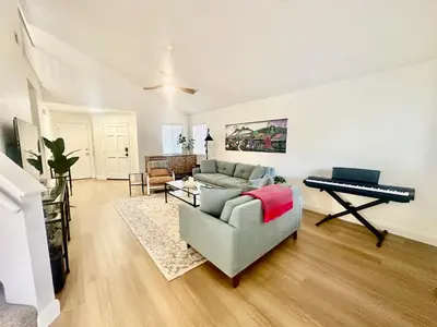a living room with a couch and a piano at Tranquil Getaway in Fresno