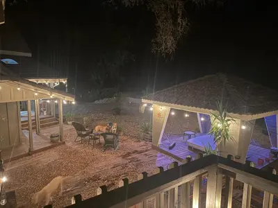 a woman sitting in a chair in a backyard at night at Gold Country Serenity! 45 Minutes to Powder! in Grass Valley
