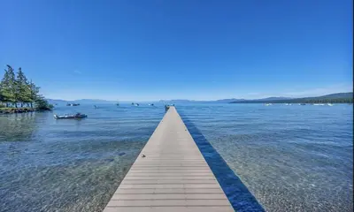 a wooden pathway in the middle of a body of water at Lakeside Condo Close to Slopes Excellent Location in Tahoe Vista