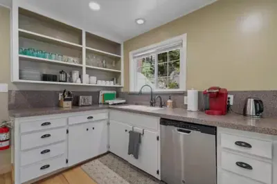 a kitchen with white cabinets and a sink at Hot TubSaunaPoolPrivate Beach Tahoe Oasis in Zephyr Cove