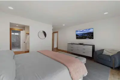 a bedroom with a large bed and a couch at Hot TubSaunaPoolPrivate Beach Tahoe Oasis in Zephyr Cove