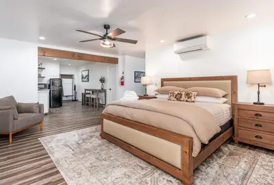 a bedroom with a large bed with two dogs on it at The Four Daughters Inn in Oakhurst