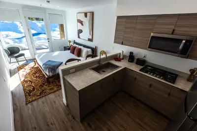 a kitchen with a sink and a bed in a room at The Sierra House in Mammoth Lakes