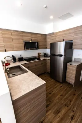 a kitchen with a stainless steel refrigerator and wooden cabinets at The Sierra House in Mammoth Lakes