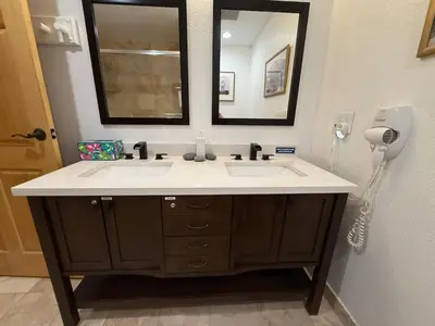 a bathroom with a sink with a mirror and a hair dryer at Family Ski Getaway in Kirkwood