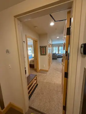 a hallway of a home with a hallway leading to a living room at Family Ski Getaway in Kirkwood