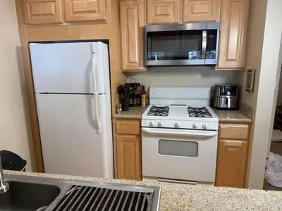 a kitchen with a white refrigerator and a microwave at Family Ski Getaway in Kirkwood