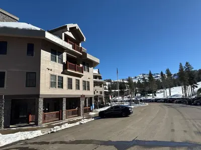 a building with a car parked next to a street at Family Ski Getaway in Kirkwood