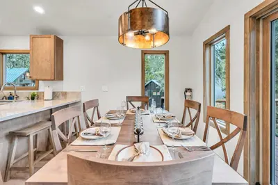 a dining room with a long table and chairs at Tahoe City Retreat - Creekside Deck & Hot Tub in Tahoe City