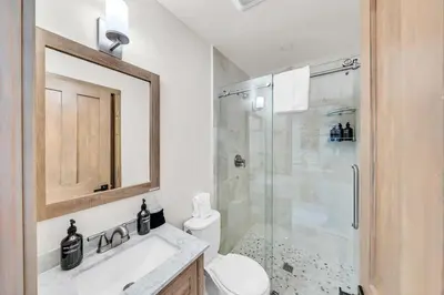 a bathroom with a shower and a toilet and a sink at Tahoe City Retreat - Creekside Deck & Hot Tub in Tahoe City