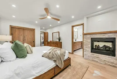 a bedroom with a bed and a fireplace at Tahoe City Retreat - Creekside Deck & Hot Tub in Tahoe City