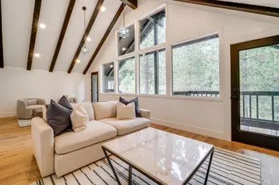 a living room with a couch and a table at Walk to Gondola Truckee Retreat with Resort Perks! in Truckee