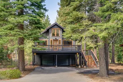 a house in the woods with a deck at Walk to Gondola Truckee Retreat with Resort Perks! in Truckee