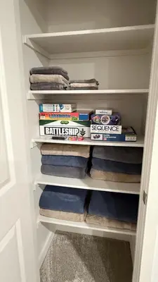 a closet filled with lots of books and towels at New Holiday Retreat in Merced in Merced
