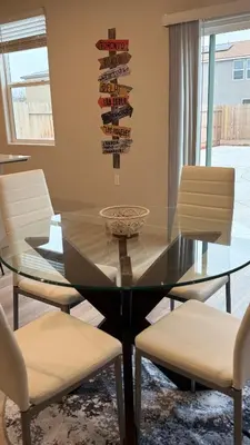 a dining room with a glass table and chairs at New Holiday Retreat in Merced in Merced