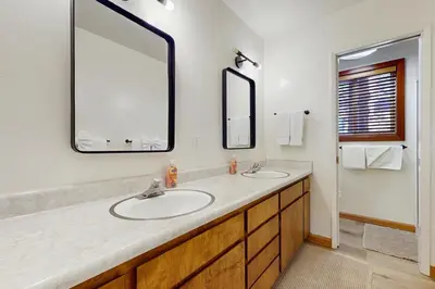 a bathroom with two sinks and a large mirror at Tahoe Alpine and Lake Escape in Carnelian Bay