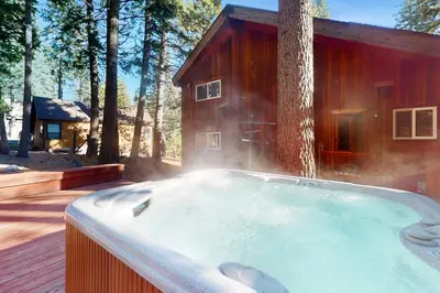 a hot tub in front of a house with a tree at Tahoe Alpine and Lake Escape in Carnelian Bay