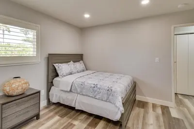 a bedroom with a bed and a dresser and a window at 2 Mi to UC Merced Modern Home with Private Yard in Merced