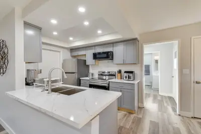 a kitchen with a sink and a counter top at 2 Mi to UC Merced Modern Home with Private Yard in Merced