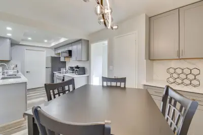 a kitchen and dining room with a table and chairs at 2 Mi to UC Merced Modern Home with Private Yard in Merced