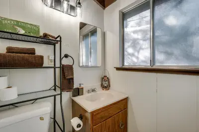 a bathroom with a sink and a window at 3 Mi to Calaveras Big Trees Group-Ready Mtn Cabin in Arnold
