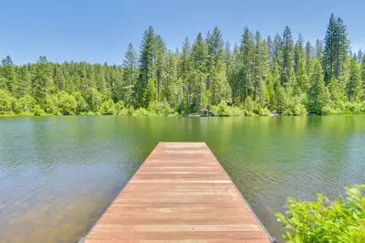 a wooden dock in the middle of a lake at 3 Mi to Calaveras Big Trees Group-Ready Mtn Cabin in Arnold