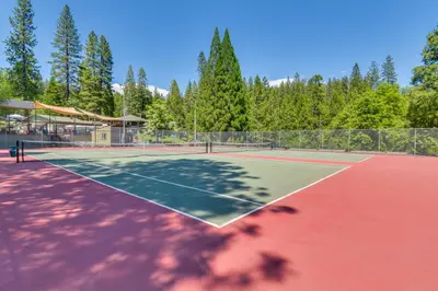 a tennis court with two tennis rackets on it at 3 Mi to Calaveras Big Trees Group-Ready Mtn Cabin in Arnold