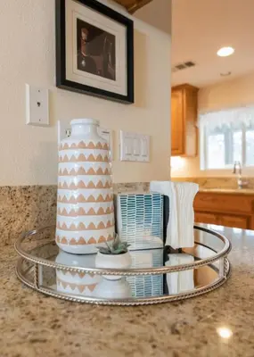 a cake on a tray on a counter in a kitchen at Hot Tub and Game Room 15 mi to Yosemite South Gate in Oakhurst
