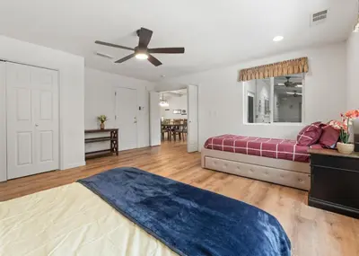 a living room with a bed and a ceiling fan at Hot Tub and Game Room 15 mi to Yosemite South Gate in Oakhurst