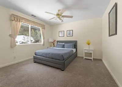 a bedroom with a bed and a ceiling fan at Hot Tub and Game Room 15 mi to Yosemite South Gate in Oakhurst