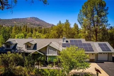 a house with solar panels on the roof at Hot Tub and Game Room 15 mi to Yosemite South Gate in Oakhurst