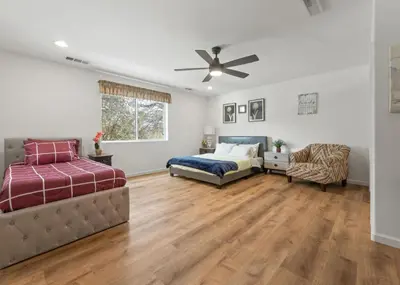 a bedroom with two beds and a ceiling fan at Hot Tub and Game Room 15 mi to Yosemite South Gate in Oakhurst